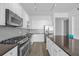 Sleek kitchen featuring stainless steel appliances, gas range, ample cabinetry, and stylish backsplash at 150 E Robinson St # 2308, Orlando, FL 32801