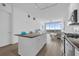 Modern kitchen featuring island, stainless appliances, and open layout flowing into the living area with skyline views at 150 E Robinson St # 2308, Orlando, FL 32801