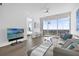 Bright living room features sleek furniture, modern lighting, and stunning city views from floor-to-ceiling windows at 150 E Robinson St # 2308, Orlando, FL 32801