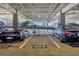 Parking garage featuring several parked luxury cars with parking space numbers at 150 E Robinson St # 2308, Orlando, FL 32801
