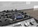 Close up of a modern gas stovetop with a bright blue flame at 150 E Robinson St # 2308, Orlando, FL 32801