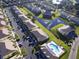 Aerial view showcases community layout with pond, pool, and residential buildings at 1523 Still Dr, Clermont, FL 34714