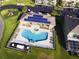 Aerial shot of a community pool and recreation center with solar panels and play area at 1523 Still Dr, Clermont, FL 34714