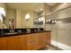Modern bathroom featuring double sinks, granite countertop, and glass enclosed shower at 1523 Still Dr, Clermont, FL 34714