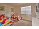 Bright bedroom featuring two twin beds, neutral carpet and a large window at 1523 Still Dr, Clermont, FL 34714