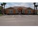 Exterior shot of a community clubhouse with ample parking and decorative landscaping at 1523 Still Dr, Clermont, FL 34714