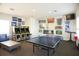 Inviting game room featuring a ping pong table, arcade games, and comfortable seating, ideal for entertainment at 1523 Still Dr, Clermont, FL 34714