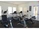 Well-lit gym featuring treadmills, elliptical, stationary bike, and rowing machine for a complete fitness regimen at 1523 Still Dr, Clermont, FL 34714