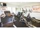 Functional gym space equipped with treadmills, elliptical machines, and motivating artwork for an enjoyable workout at 1523 Still Dr, Clermont, FL 34714