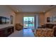 Bright living room featuring sliding glass doors with access to a private pool view and outdoor living space at 1523 Still Dr, Clermont, FL 34714