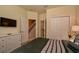 Main bedroom featuring neutral decor, a dresser with mounted television and a hallway view at 1523 Still Dr, Clermont, FL 34714