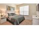 Relaxing main bedroom featuring neutral decor, side tables with lamps and a window at 1523 Still Dr, Clermont, FL 34714