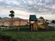 Inviting community playground with a slide, swings, and climbing structure, perfect for Gathering activities at 1523 Still Dr, Clermont, FL 34714