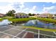 Scenic pond view from the screened patio overlooking tranquil water and neighborhood at 1523 Still Dr, Clermont, FL 34714