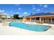 Beautiful community pool and hot tub area with solar panels on the clubhouse roof at 1523 Still Dr, Clermont, FL 34714