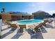 Community pool and spa area with solar panels on the clubhouse roof and lots of loungers at 1523 Still Dr, Clermont, FL 34714