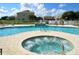 Relaxing community pool with inviting in-ground hot tub, perfect for soaking up the sun on a beautiful day at 1523 Still Dr, Clermont, FL 34714