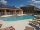 Inviting community pool area with solar panels, hot tub, and outdoor lounge furniture at 1523 Still Dr, Clermont, FL 34714