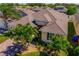 Beautiful aerial view of a well-maintained home with lush landscaping and a brick driveway at 1703 Leatherback Ln, St Cloud, FL 34771