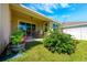 Cozy covered back patio with outdoor seating and beautifully landscaped yard, great for relaxing or entertaining at 1703 Leatherback Ln, St Cloud, FL 34771