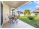 Cozy covered back porch with outdoor seating and a view of the well-maintained backyard at 1703 Leatherback Ln, St Cloud, FL 34771