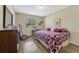Bright bedroom with luxury vinyl plank flooring, and a large window with blinds at 1703 Leatherback Ln, St Cloud, FL 34771