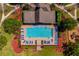 A top-down shot of a community pool shows lounge chairs, landscaping, and a secure fenced perimeter at 1703 Leatherback Ln, St Cloud, FL 34771
