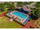 Elevated shot of the community pool, featuring ample seating, covered lounging area and well-kept grounds at 1703 Leatherback Ln, St Cloud, FL 34771