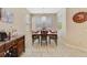 Bright dining room with tile flooring, decorative lighting and place settings at 1703 Leatherback Ln, St Cloud, FL 34771