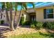 Inviting home exterior featuring well-manicured landscaping, a two-car garage, and a welcoming entryway at 1703 Leatherback Ln, St Cloud, FL 34771