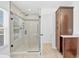 Tiled bathroom with glass shower and built-in storage at 1705 Ridgemoor Dr, Mascotte, FL 34753