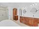 Bright bathroom featuring a dual vanity with modern fixtures and a separate glass enclosed shower at 1705 Ridgemoor Dr, Mascotte, FL 34753