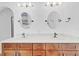 Bathroom with modern fixtures, double vanity, and decorative mirrors at 1705 Ridgemoor Dr, Mascotte, FL 34753