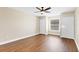 Bedroom with wood-look floors, large window, ceiling fan and closet at 1705 Ridgemoor Dr, Mascotte, FL 34753