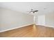 Spacious bedroom with ceiling fan, wood-look floors, and double door closet at 1705 Ridgemoor Dr, Mascotte, FL 34753