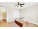 Bedroom with wood-look flooring, ceiling fan and a glass desk, bright and airy at 1705 Ridgemoor Dr, Mascotte, FL 34753