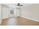 Bedroom with wood-look floors, window, ceiling fan and closet at 1705 Ridgemoor Dr, Mascotte, FL 34753