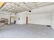 Spacious garage with smooth concrete flooring and overhead storage at 1705 Ridgemoor Dr, Mascotte, FL 34753