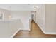 Upstairs hallway with hardwood floors, modern lighting and neutral colored walls at 1705 Ridgemoor Dr, Mascotte, FL 34753