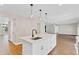 Kitchen island with sink and storage overlooking an open floor plan at 1705 Ridgemoor Dr, Mascotte, FL 34753