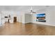 Open floor plan with fireplace, TV, wood floors and view of kitchen at 1705 Ridgemoor Dr, Mascotte, FL 34753