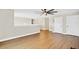 Bright living room with modern ceiling fan, wood floors and neutral wall colors at 1705 Ridgemoor Dr, Mascotte, FL 34753
