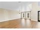 Bright living room with wood-look flooring, large windows, and elegant chandelier at 1705 Ridgemoor Dr, Mascotte, FL 34753