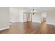 Open floor plan with wood-look floors leading to a staircase and kitchen at 1705 Ridgemoor Dr, Mascotte, FL 34753