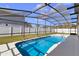 A bright blue swimming pool in screened enclosure at 1705 Ridgemoor Dr, Mascotte, FL 34753