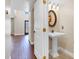 Charming powder room featuring pedestal sink and decorative mirror at 1705 Ridgemoor Dr, Mascotte, FL 34753