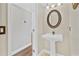 Powder room featuring a pedestal sink, and decorative mirror at 1705 Ridgemoor Dr, Mascotte, FL 34753