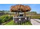 Outdoor tiki bar with a thatched roof, seating for four and views of the property at 17117 Heartwood Loop, Winter Garden, FL 34787
