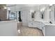 Bright bathroom featuring double vanity, soaking tub, and beautiful tile flooring at 17117 Heartwood Loop, Winter Garden, FL 34787