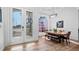 Elegant dining room showcasing hardwood floors, a large arched window, and a modern light fixture over the dining table at 17117 Heartwood Loop, Winter Garden, FL 34787